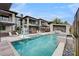 Luxury home featuring a resort-style pool with a basketball hoop, lounge chairs, and lush landscaping at 1704 Tangiers Dr, Henderson, NV 89012