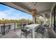 This covered balcony includes an outdoor dining area with seating and scenic views at 1704 Tangiers Dr, Henderson, NV 89012