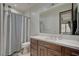 Bathroom featuring a wooden vanity with a white countertop and a shower with gray curtain at 1704 Tangiers Dr, Henderson, NV 89012