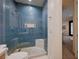 Bathroom featuring blue tiled shower with glass door and mosaic tile floor at 1704 Tangiers Dr, Henderson, NV 89012