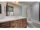 Bathroom with a tub-shower, white and brown vanity with sink and wall mirror at 1704 Tangiers Dr, Henderson, NV 89012
