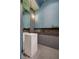 Contemporary powder room featuring mosaic tile walls, a pedestal sink, and a sleek, minimalist design at 1704 Tangiers Dr, Henderson, NV 89012
