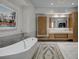 Bright bathroom featuring a soaking tub, unique vanity, and stylish decor at 1704 Tangiers Dr, Henderson, NV 89012
