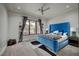 Stylish bedroom with blue bed, neutral carpet, and large windows with basketball decor at 1704 Tangiers Dr, Henderson, NV 89012
