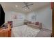 Cozy bedroom with a plush rug, comfortable sofa, and a ceiling fan at 1704 Tangiers Dr, Henderson, NV 89012