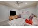 Bright bedroom featuring a large TV, neutral walls, and a soft shag rug at 1704 Tangiers Dr, Henderson, NV 89012