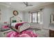 Bedroom featuring a tufted headboard, patterned rug, and ample natural light at 1704 Tangiers Dr, Henderson, NV 89012