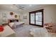 Cozy bedroom featuring a sitting area, plush rug, and sliding glass doors to patio at 1704 Tangiers Dr, Henderson, NV 89012