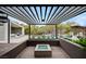 Inviting outdoor seating area with a modern fire pit and views of the pool and landscaped backyard at 1704 Tangiers Dr, Henderson, NV 89012
