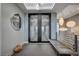 Stylish foyer with designer light fixtures, patterned carpet, and a modern bench at 1704 Tangiers Dr, Henderson, NV 89012