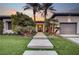 Beautifully landscaped front yard with palm trees and a modern walkway leading to the house at 1704 Tangiers Dr, Henderson, NV 89012