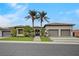 Attractive single-story home featuring a well-manicured lawn, palm trees, and a three-car garage at 1704 Tangiers Dr, Henderson, NV 89012