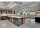 Modern kitchen with stainless steel appliances, bar stool seating, and an adjacent dining area at 1704 Tangiers Dr, Henderson, NV 89012