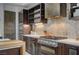 This modern kitchen features stainless steel appliances, custom cabinetry, and stylish backsplash at 1704 Tangiers Dr, Henderson, NV 89012