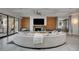 Bright living room with a fireplace, a large television, and floor to ceiling sliding doors at 1704 Tangiers Dr, Henderson, NV 89012