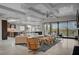 Open-concept living room boasts modern lighting, neutral colors, and access to a private balcony at 1704 Tangiers Dr, Henderson, NV 89012