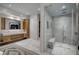 Modern bathroom featuring a glass-enclosed shower, double vanity, and stylish fixtures at 1704 Tangiers Dr, Henderson, NV 89012