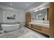 Luxurious bathroom featuring a soaking tub, double vanity, and modern fixtures at 1704 Tangiers Dr, Henderson, NV 89012