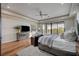 Bright bedroom featuring hardwood floors, balcony access, and a modern design at 1704 Tangiers Dr, Henderson, NV 89012