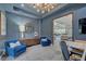 Stylish office space featuring a large mirror, modern furniture, and an open layout with an adjacent living area at 1704 Tangiers Dr, Henderson, NV 89012