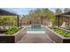 Stunning backyard oasis with a sparkling pool, water feature, and lush landscaping at 1704 Tangiers Dr, Henderson, NV 89012