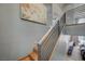 Modern staircase with sleek metal railings, wood steps, and open floorplan views at 1704 Tangiers Dr, Henderson, NV 89012