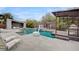 Beautiful backyard showcasing a sparkling swimming pool with a basketball hoop and a covered lounge area at 1704 Tangiers Dr, Henderson, NV 89012
