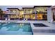 Stunning backyard with a large swimming pool, hot tub, lounge chairs, and modern architecture at 1704 Tangiers Dr, Henderson, NV 89012