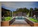 Beautiful water feature with decorative screens, lush landscaping, and inviting wooden pathway at 1704 Tangiers Dr, Henderson, NV 89012