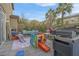 Wide angle showing deck with patio furniture, barbeque, and playset at 193 Calabria Peak Ct, Henderson, NV 89012