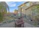 Fenced backyard with deck, patio furniture, BBQ, and fire pit at 193 Calabria Peak Ct, Henderson, NV 89012