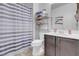 A clean bathroom with a sink, toilet, and shower behind a striped curtain at 193 Calabria Peak Ct, Henderson, NV 89012