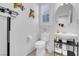 Cozy bathroom featuring a pedestal sink, commode, and decorative bird artwork at 193 Calabria Peak Ct, Henderson, NV 89012