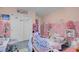 Charming pink bedroom with twin beds, playful decor, and ample closet space at 193 Calabria Peak Ct, Henderson, NV 89012