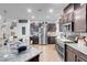 Kitchen with granite countertops, stainless steel appliances and dark wood cabinets at 193 Calabria Peak Ct, Henderson, NV 89012