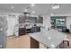 Granite countertops adorn the large kitchen island and stainless steel appliances at 193 Calabria Peak Ct, Henderson, NV 89012