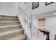 Staircase with carpeted steps and white railings leading to upper level at 193 Calabria Peak Ct, Henderson, NV 89012