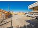 Large, empty, gravel backyard featuring a pick up truck and a partial view of buildings in the distance at 203 N 13Th St, Las Vegas, NV 89101