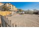 Spacious backyard with potential for customization, featuring ample parking, desert landscape, and security fence at 203 N 13Th St, Las Vegas, NV 89101