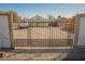 Gated front yard featuring desert landscaping and security fence, with potential parking for multiple vehicles at 203 N 13Th St, Las Vegas, NV 89101