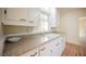 Compact kitchen area featuring light walls, wood-look floors, and small window at 203 N 13Th St, Las Vegas, NV 89101