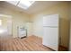 Small kitchen area features light walls, wood-look floors, white appliances, and ample natural light at 203 N 13Th St, Las Vegas, NV 89101