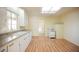 Bright kitchen featuring light walls, wood-look floors, stainless steel sink, and an oven at 203 N 13Th St, Las Vegas, NV 89101