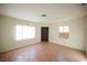 An empty living room features light walls, wood-look floors and natural light from the windows at 203 N 13Th St, Las Vegas, NV 89101