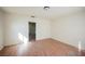 Empty living room features light walls, wood-look floors and doorway access to the kitchen at 203 N 13Th St, Las Vegas, NV 89101