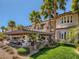 Expansive backyard featuring a covered patio, outdoor kitchen, and a sparkling pool surrounded by lush landscaping at 2038 Cherry Creek Cir, Las Vegas, NV 89135