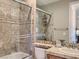 Beautiful bathroom featuring a glass shower, tile surround, and a granite sink and vanity at 2038 Cherry Creek Cir, Las Vegas, NV 89135
