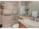 A modern bathroom showcases a tiled walk-in shower, a stylish vanity, and elegant fixtures for a spa-like experience at 2038 Cherry Creek Cir, Las Vegas, NV 89135