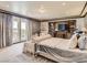 Serene bedroom with access to a balcony, complemented by a built-in entertainment center, offering relaxation and convenience at 2038 Cherry Creek Cir, Las Vegas, NV 89135