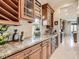 A butler's pantry features granite countertops, wine racks, and ample storage, adding elegance and functionality at 2038 Cherry Creek Cir, Las Vegas, NV 89135